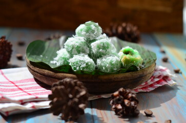 kelepon or klepon or onde-onde made from glutinous rice flour and filled with brownn sugar covered with grated coconut. Some people called this traditional cake from Indonesia as Onde-onde.