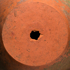 hole on a clay pot, broken earthenware surface background texture, closeup wallpaper