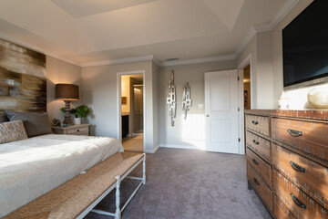 Furnished contemporary master bedroom in a town home. Home decorating or real estate concept.