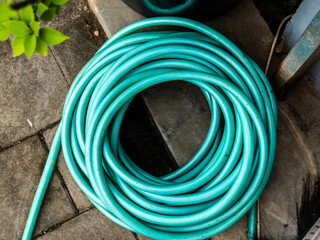Tosca colored water hose rolled up
