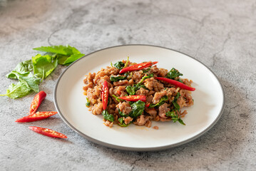 Stir fried minced meat with basil on background as Thai street food for local recipe