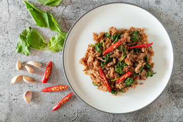 Stir fried minced meat with basil on background as Thai street food for local recipe