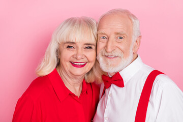 Portrait of attractive amorous cheery gray-haired couple bonding anniversary isolated over pink pastel color background