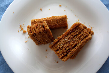 pieces of honey cake on a white plate