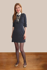 Blonde girl in blue polka dot dress