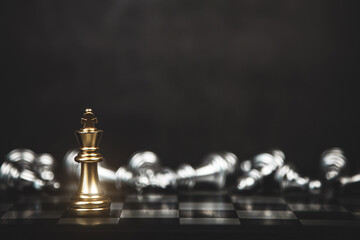 Close up king chess standing with falling chess on the back concept of team player or business team...