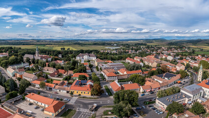 Fototapeta na wymiar Aerial view of historic Szecseny town on the Hungarian Slovakian border with traces of medieval city wall, towers and white wall Forgach castle