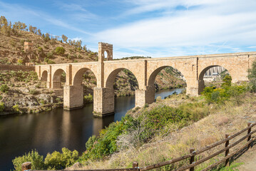 Fototapeta na wymiar Stone old bridge over river in summertime