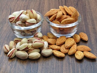 Pistachio and almonds on wooden background 