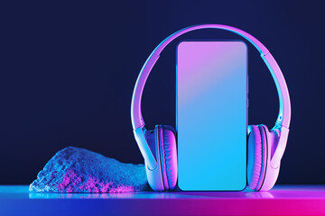 Smartphone mockup display with wireless headphones in neon lights cyberpunk futuristic background. Copy space. Audio technology apps, music podcasts books