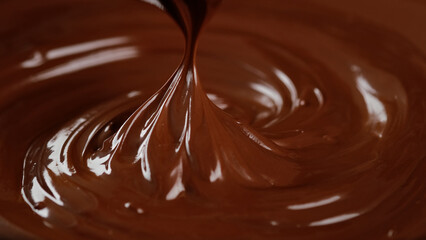 Stirring melted liquid chocolate with steel whisk. Mixing molten chocolate or dark caramel. Cooking chocolate dessert