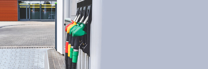 Long Banner, gas station with petrol and diesel hoses. Against the backdrop of a window.