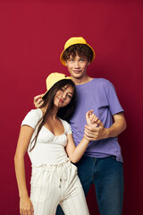 Man and woman in colorful t-shirts stylish clothes hats isolated background