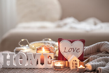 Cozy Valentine's Day background with a candle and a decorative heart.