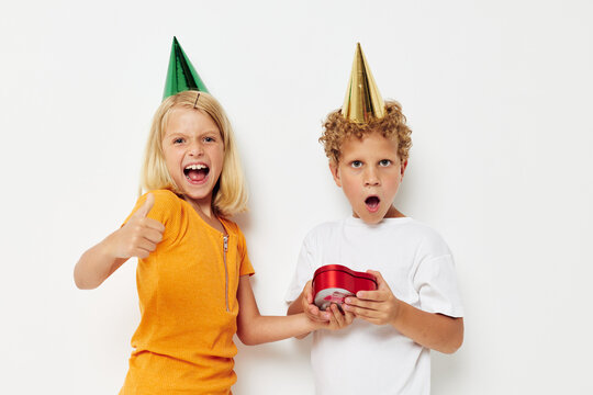 Cheerful boy with girl with hats gift birthday holiday