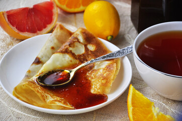 Pancakes on a plate with Citrus jam with orange and grapefruit