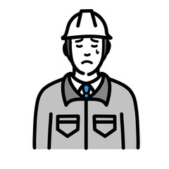 悲しそうに涙を流しているヘルメットをかぶった現場作業員の男性
