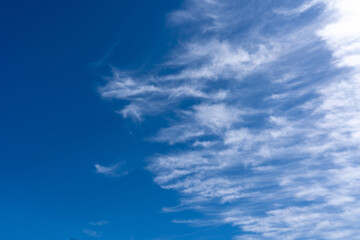 Naklejka na ściany i meble High cirrus clouds against the blue sky