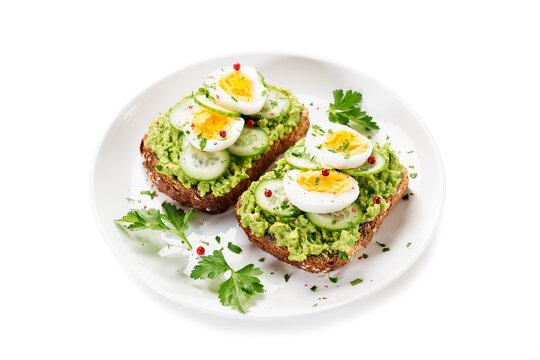 Healthy Breakfast Toast With Avocado Smash And Boiled Egg. Isolated On White Background