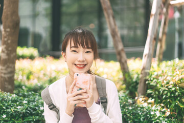 Portrait of happy smile young adult asian student woman with backpack at outdoor on day.