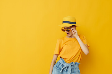 beautiful girl in a yellow hat Youth style casual wear in sunglasses Lifestyle unaltered