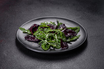 Fresh delicious salad with sleeves, spinach and beet leaves with olive oil