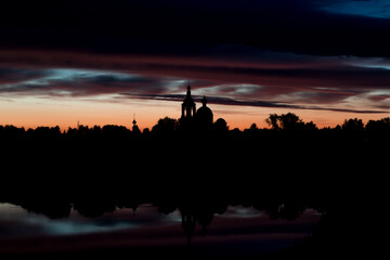 colorful sunset over church and lake