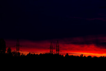 Fototapeta premium Bright red order and electric transmission towers