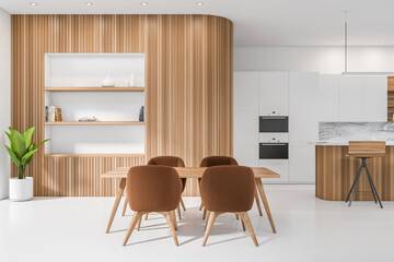 Bright kitchen room interior with double oven, dining table