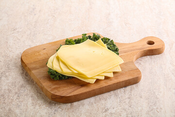 Sliced Gouda cheese over board