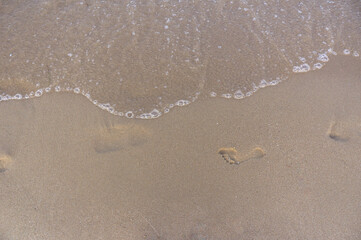 Sea surf, waves rolls on a sandy beach