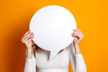 Student hold blank white speech balloon isolated on an orange studio background. copy space