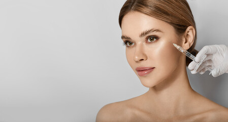 Beauty injections into beautiful face. Smoothing of mimic wrinkles around eyes using beauty...