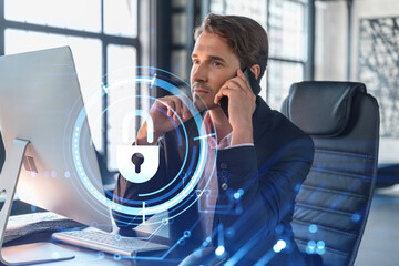 Businessman in suit has conference call of cyber security in compliance division to protect clients confidential information. IT hologram lock icons over office background with panoramic windows.