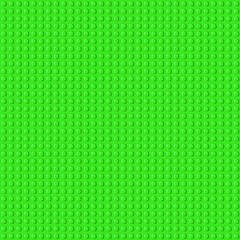 Green plastic baseplate from popular brand children constructor with assembly knots