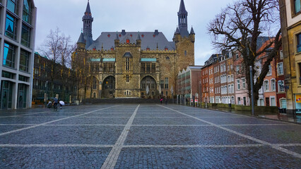 Ancient stone walls and details of Aachen Town Hall on a background of the evening sky
