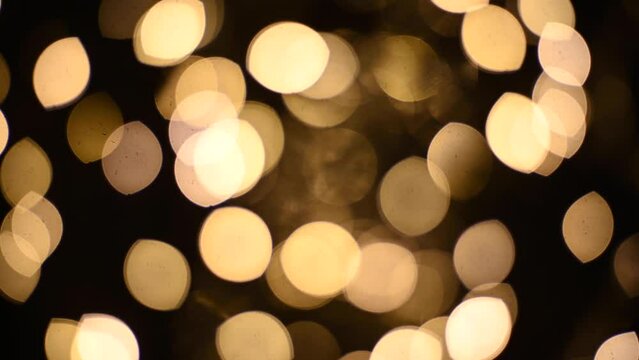 Abstract blurry, low depth of field bokeh light shapes. Vivid, colourful light effects, 4K background video clip with different shapes and dots in various colours. Perfect for Christmas backgrounds