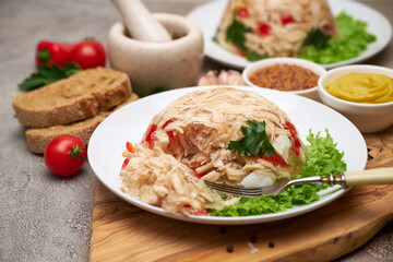 Delicious chicken aspic on a plate on concrete table