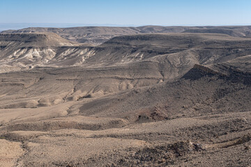 Fototapeta na wymiar View of Ramon Crater from West to East as seen from Mount Ramon, a 500 m deep, the world's largest erosion cirque, located in the Negev Desert, south of Beer Sheba, Israel. 
