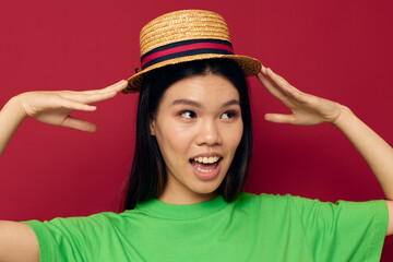 woman with Asian appearance in a green t-shirt gesturing with his hands fun isolated background unaltered