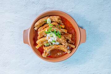 Deunggalbijjim, Korean Braised Pork Rib : For this dish, pig backbone is braised with mukeunji (aged kimchi). After being seasoned and simmered in broth, the mukeunji becomessoft and savory.