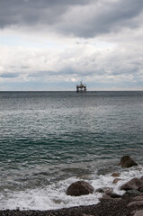 Black Sea coast and an old oceanographic platform on a cloudy day near Katziveli resort, Crimea, Russian Federation