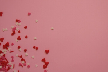 pink background with sprinkles hearts with space for text