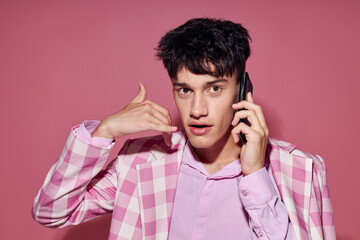 pretty man fashionable talking on the phone pink blazer posing studio Lifestyle unaltered