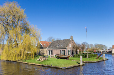 Fototapeta na wymiar Typical dutch house at the canal in Heeg, Netherlands