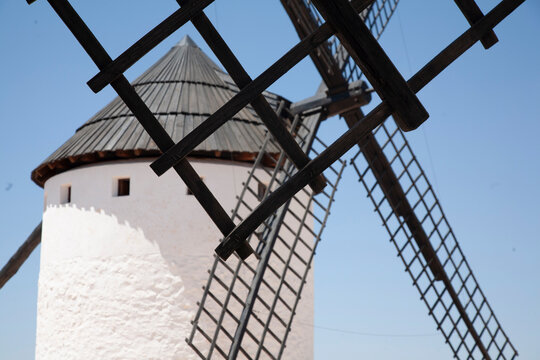 Old windmills in the city of Consuegra. White windmills and detail of their wind blades. Castilian landscape