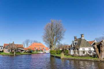 Naklejka na ściany i meble Historic houses at the central canal of Heeg, Netherlands