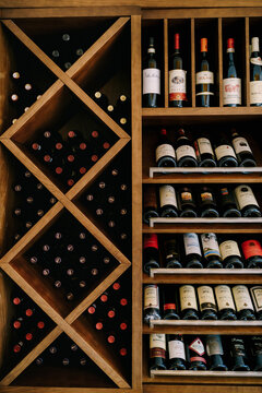 Budva, Montenegro - 05 june 2020: A wooden wine cabinet with bottles of wine.