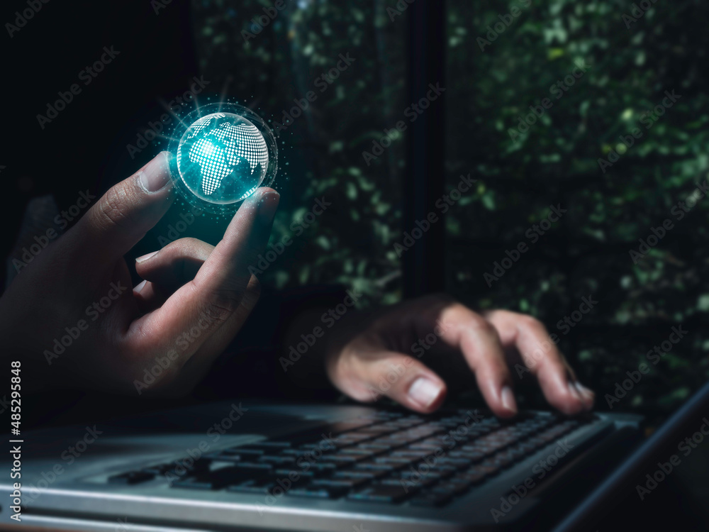 Poster hand holding a futuristic virtual small blue planet, digital link tech while using a laptop computer