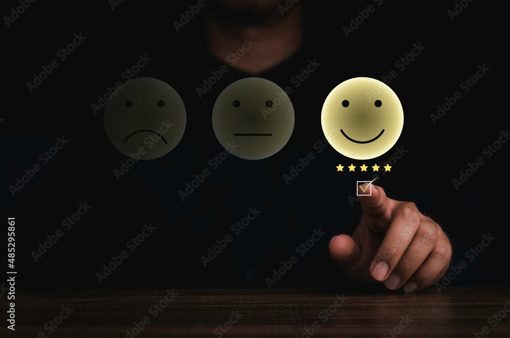 Poster businessman's hand pressing with a checkmark on checkbox on smiley face emoticon on virtual touch sc